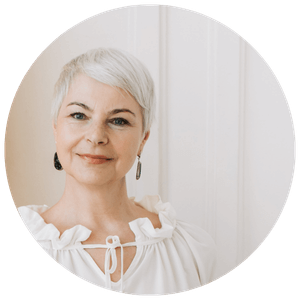 Liesl-testimonial woman with white hair wearing white top soft smile