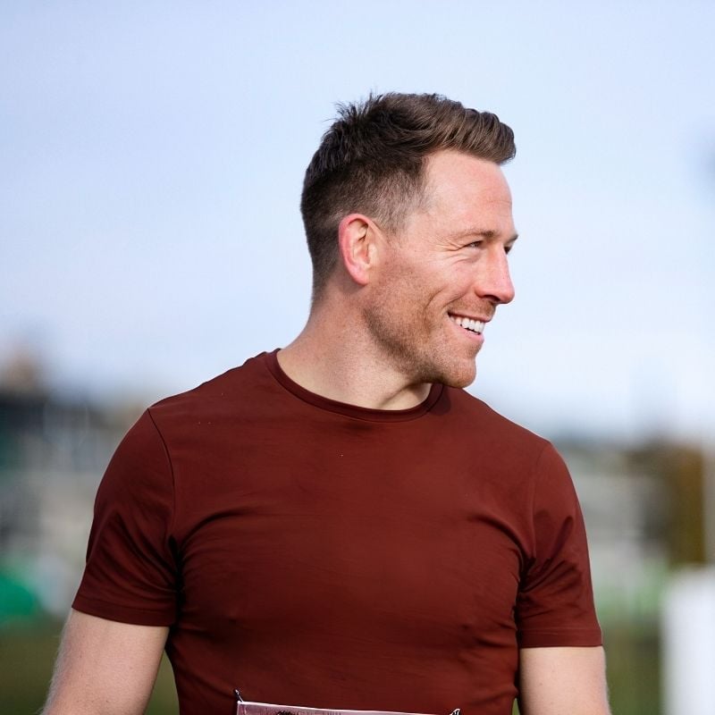 acid-reflux-food-reactions-case-study fit man standing outside looking sideways smiling
