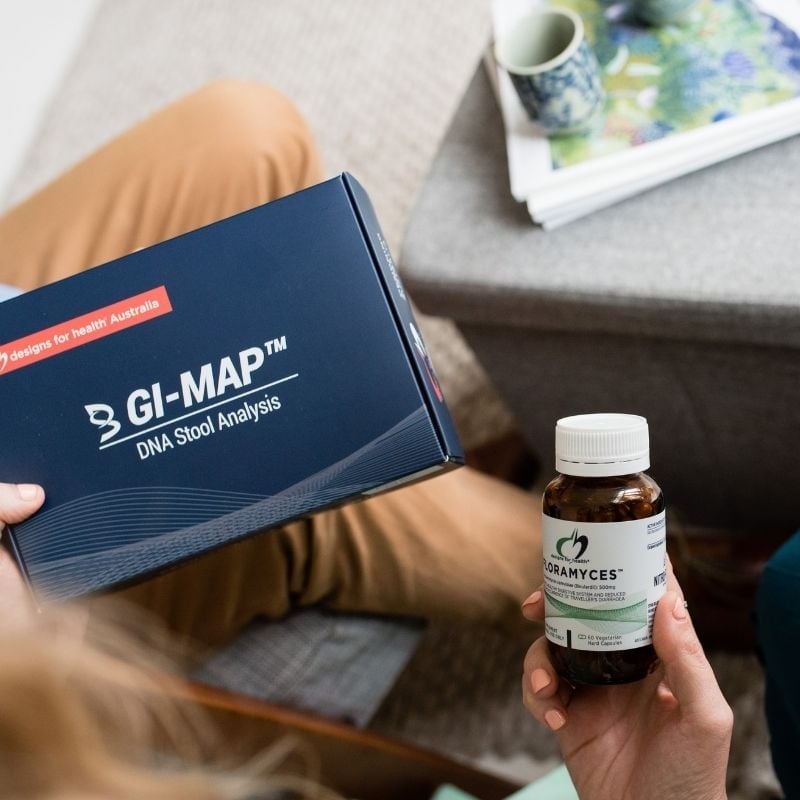 acid-reflux-functional-medicine-root-cause melbourne functional medicine clinic manager holding gi map dna stool analysis test kit floramyces probiotics