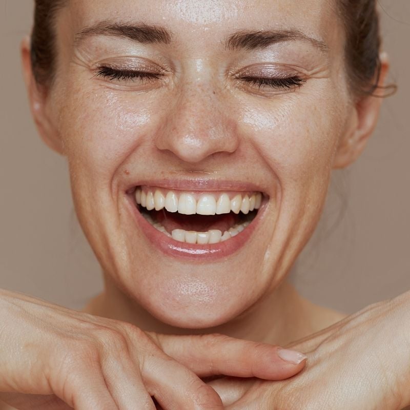 acne-functional-medicine-root-cause front profile woman's face fresh clear skin big smile