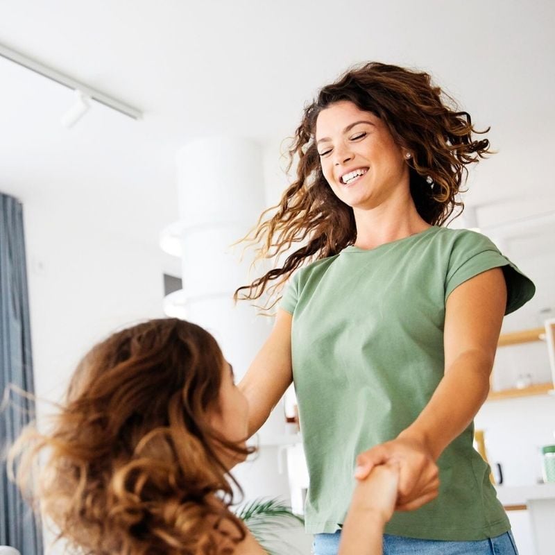atrial-fibrillation-functional-medicine-root-cause middle aged woman dancing in kitchen with daughter