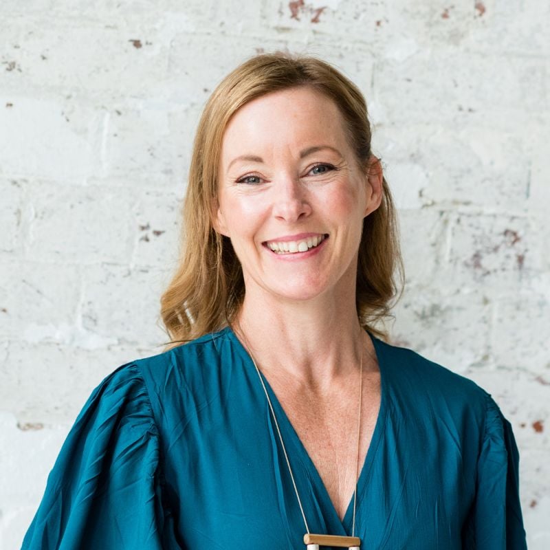health coach bee pennington wearing teal dress standing smiling