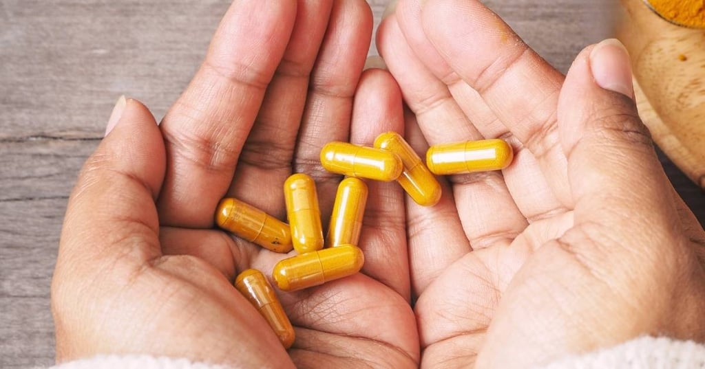 two hands cupped together holding berberine supplement capsules