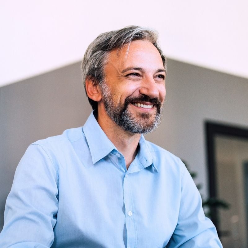 cardiovascular-disease-functional-medicine-root-cause side profile of middle aged man with good cardiometabolic health smiling gazing out window