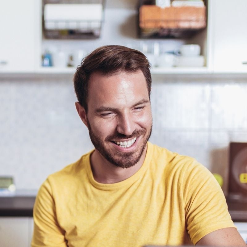 gastroparesis-functional-medicine-root-cause middle aged man sitting in bright room smiling