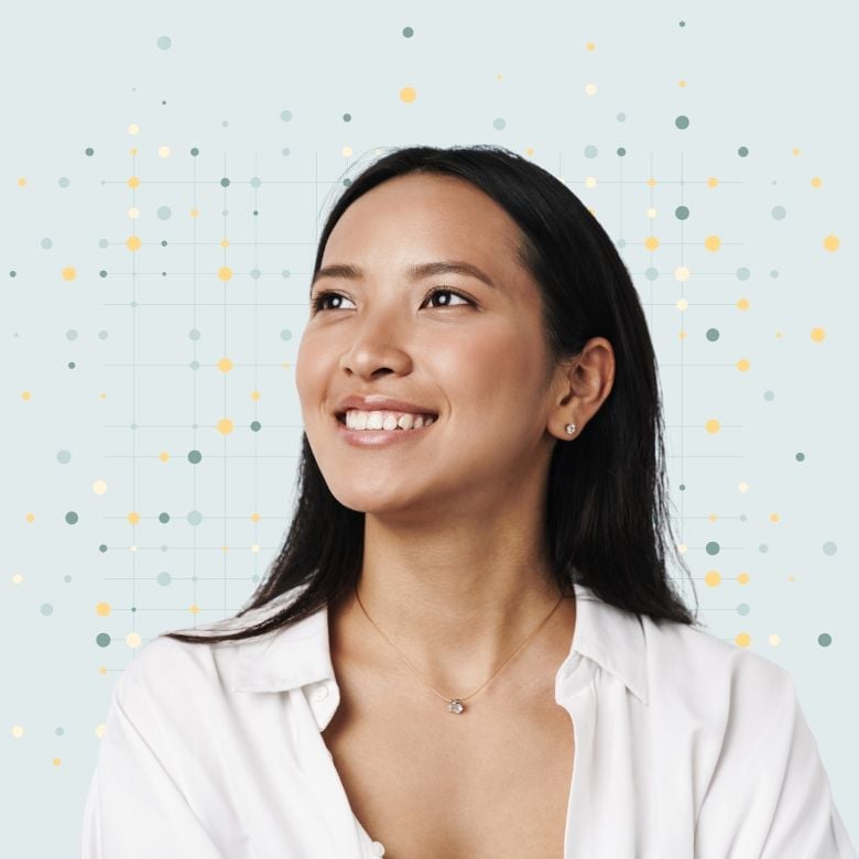 young woman looking up to the right wearing white shirt and necklace