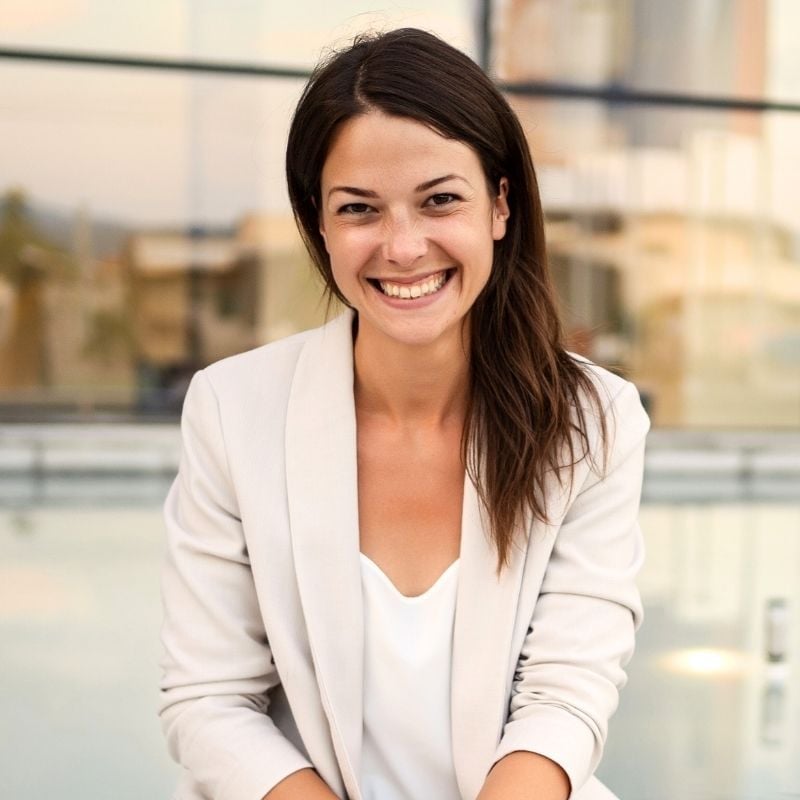 vibrant middle aged woman sitting with big smile