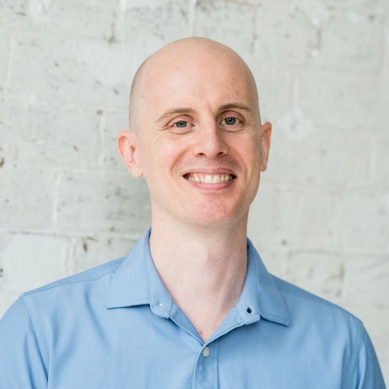 jabe brown functional medicine practitioner wearing blue shirt standing smiling
