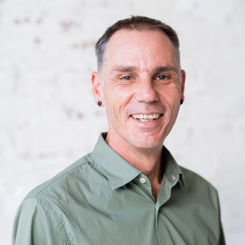 mark payne functional medicine practitioner standing smiling