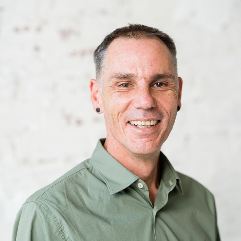 mark-payne mark payne functional medicine practitioner wearing green shirt standing smiling