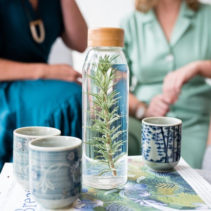 melbourne-functional-medicine-faq-contact-form glass flask filled with water infused with sprig rosemary next to three ceramic cups