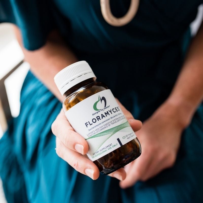 parasites-functional-medicine-root-cause melbourne functional medicine health coach holding floramyces probiotics for parasites