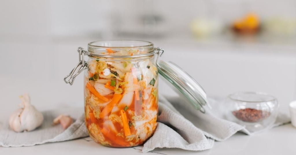 mason jar lid open full of fermented vegetables
