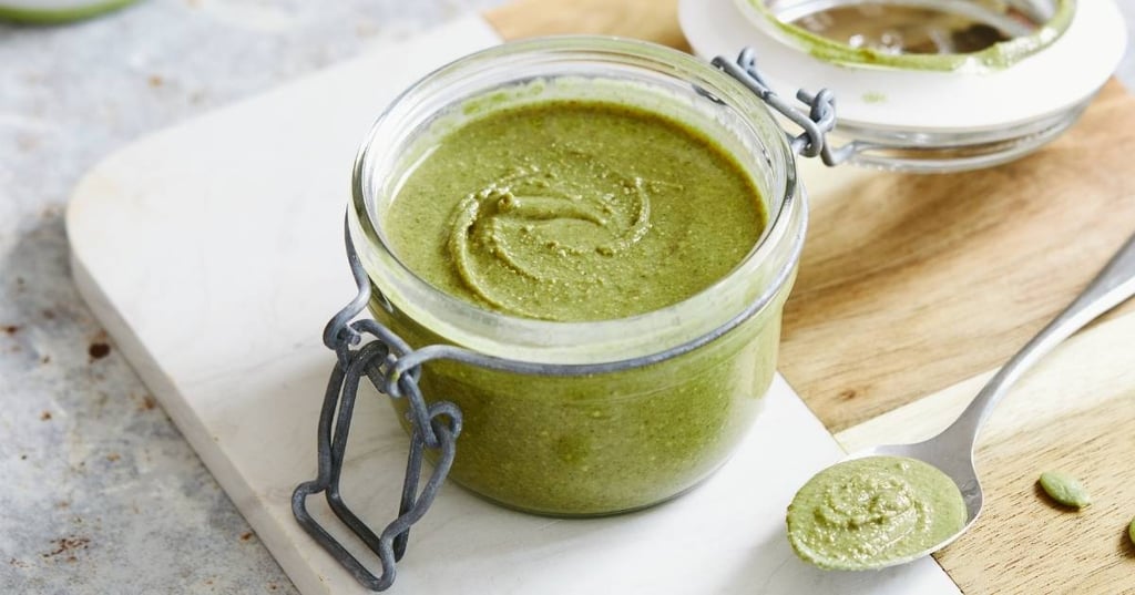 recipes-for-vegans-hero small jar of green pumpkin seed nut butter on wooden marble chopping board