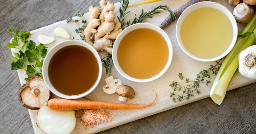 strengthening-immunity-ward-off-illness-this-winter-hero wooden chopping board with small bowls immune strengthening broth ginger mushrooms herbs onion carrot