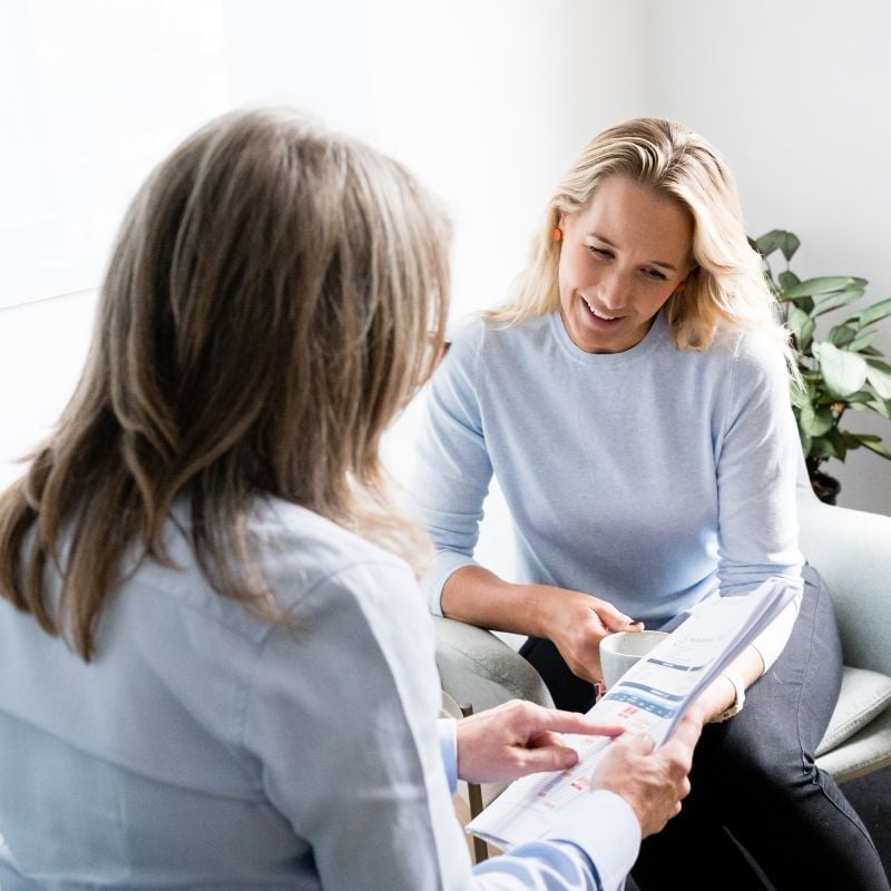 functional medicine practitioner rebecca hughes health coach jessica cairns discussing patient results