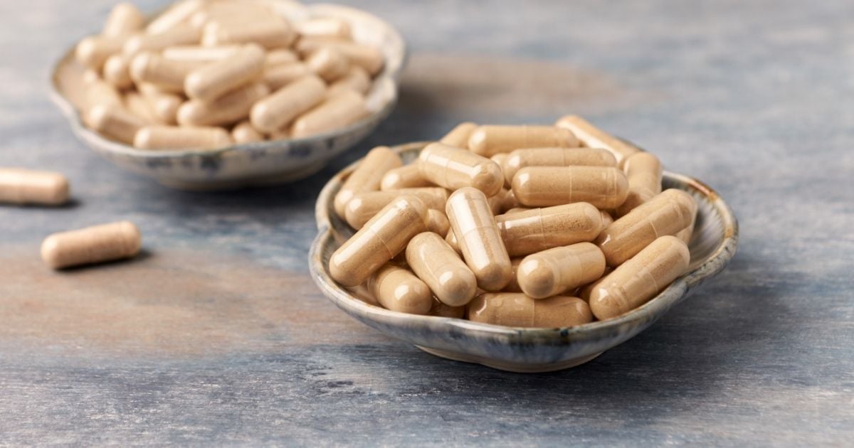 small ceramic dish filled with adaptogenic herb capsules