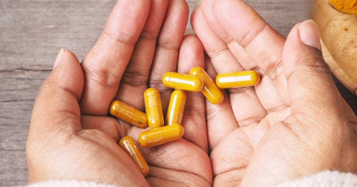 two hands cupped together holding berberine supplement capsules