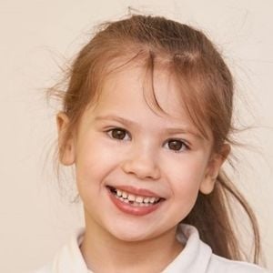 child with vibrant health skin looking at camera smiling