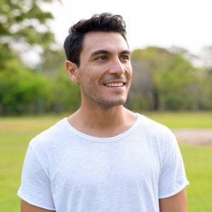 middle aged fit healthy male standing outside nature smiling
