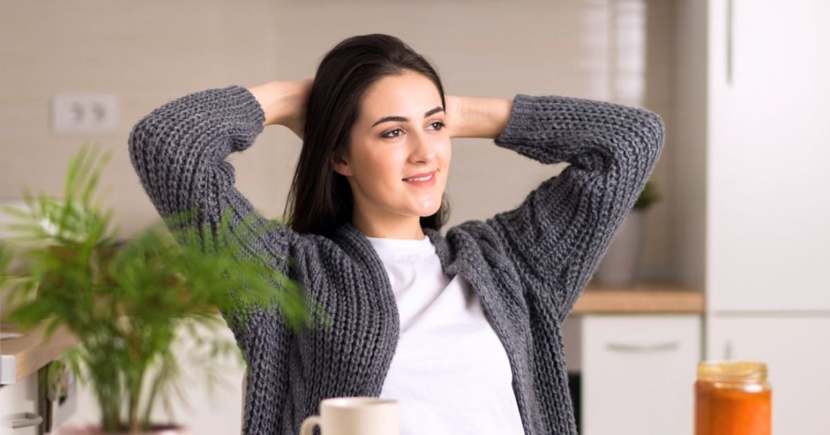 young woman sitting at table eating mindfully