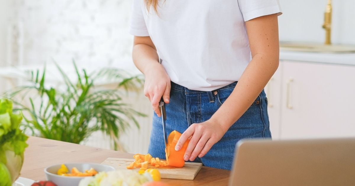 young woman preparing nutritious meal in kitchen