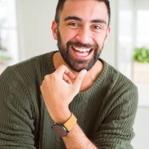 middle aged male healthy skin smiling hand resting on chin